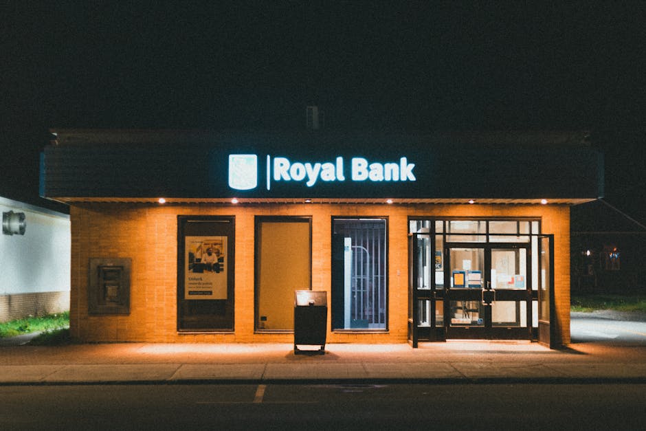 Exterior view of a Royal Bank building at night with glowing facade lights