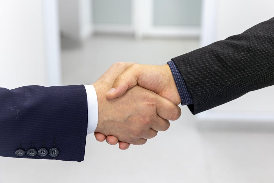 Close-up of a handshake in a business environment, symbolizing partnership